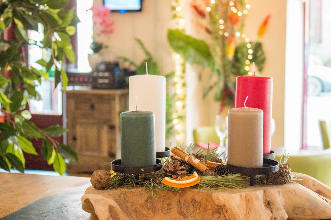a wooden table topped with candles and orange slices