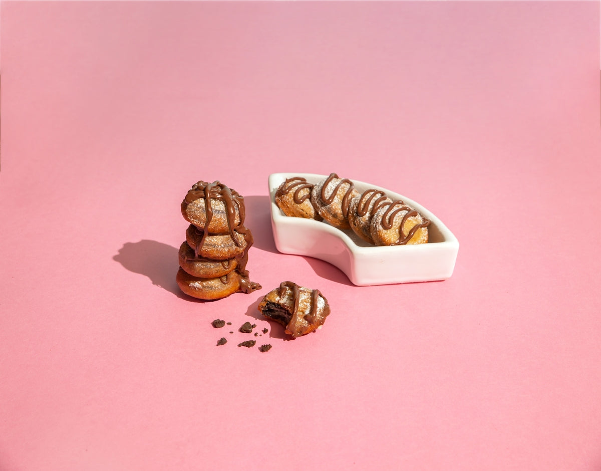 a pink table with a bowl of food and a few pieces of bread