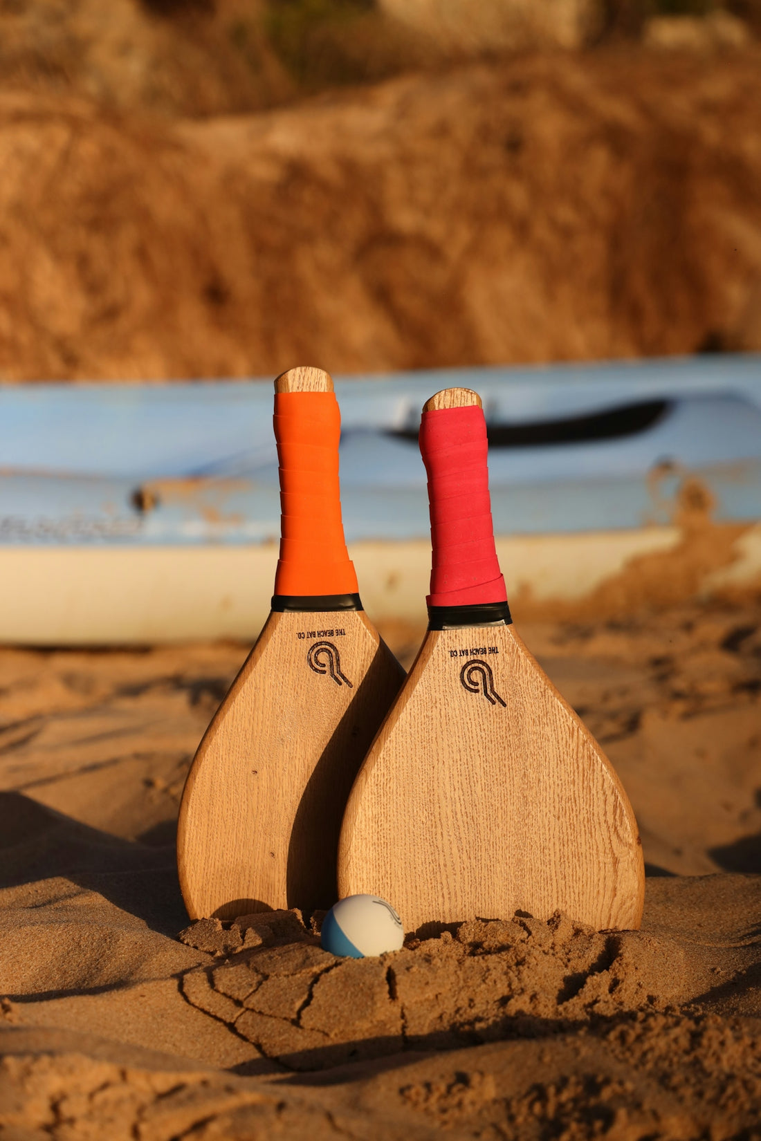 a couple of paddles sitting on top of a sandy beach