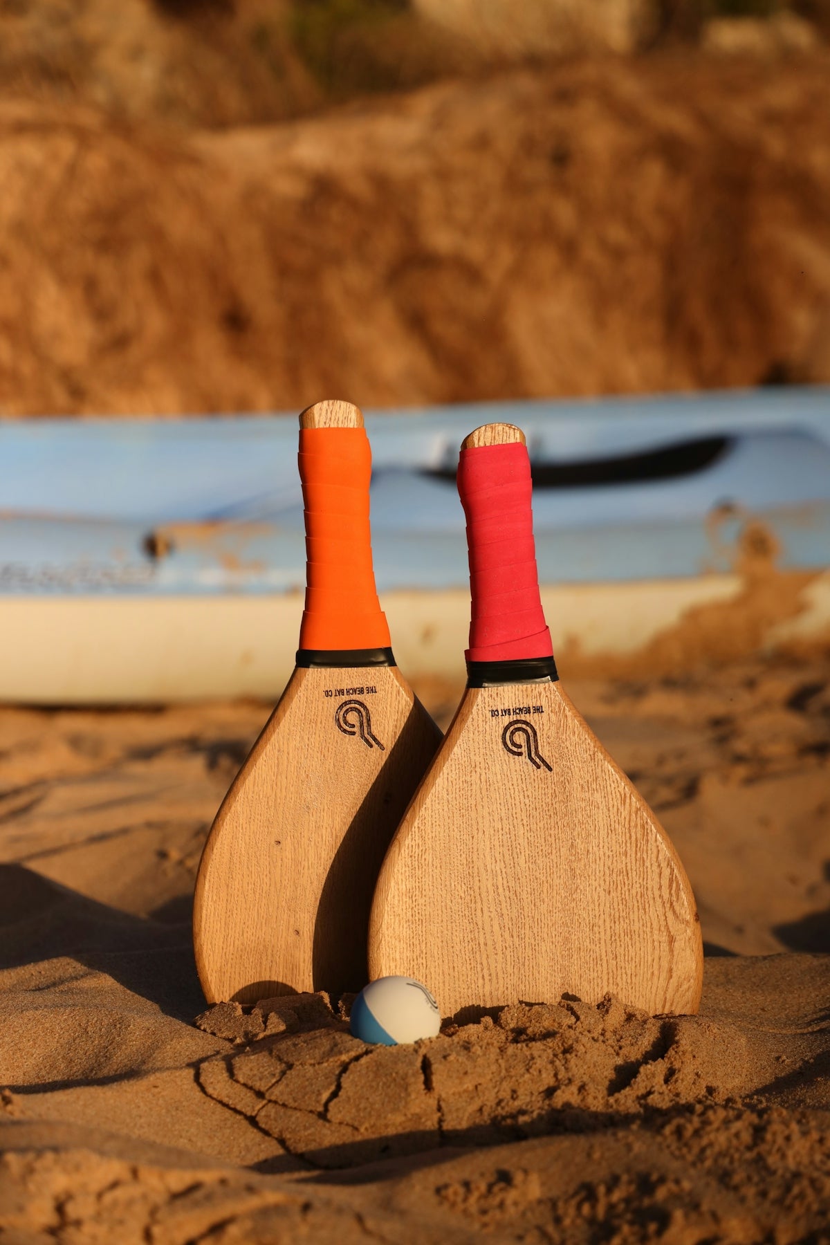 a couple of paddles sitting on top of a sandy beach